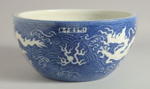 A CHINESE BLUE AND WHITE PORCELAIN SEA WATER DRAGON BOWL, the exterior with incised white dragons on