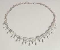 A SUPERB 14CT WHITE GOLD DIAMOND SET NECKLACE, set with numerous pear shaped diamonds.
