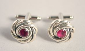 A PAIR OF SILVER RUBY KNOT CUFF LINKS.