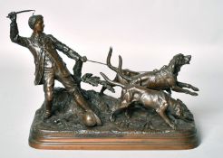 E. DUBUCAND (19TH CENTURY, FRENCH. A BRONZE OF A YOUNG MAN WITH THREE HOUNDS Signed, 7.5ins (19cm)
