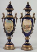 A PAIR OF SEVRES STYLE DARK BLUE PORCELAIN AND ORNATE TWO HANDLED VASE AND COVERS with reverse