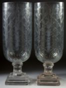 A GOOD PAIR OF ETCHED GLASS HURRICANE LAMPS on square bases.