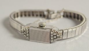 AN 18CT WHITE GOLD ART DECO DIAMOND SET COCKTAIL WATCH.