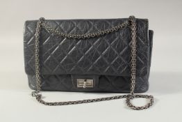 A CHANEL PADDED BLUE BAG. 32cm long, 20cm high with long chrome chain 48cm, in a Chanel dust bag.