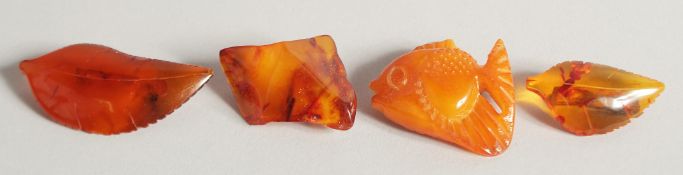FOUR VARIOUS AMBER BROOCHES. 34gms.