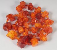 A GOOD FACETED AMBER GRADUATED NECKLACE, 32 beads, 25ins long, 100gms.