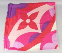 A LARGE LOUIS VUITTON SHAWL in red and blue with Louis Vuitton emblem. 140cm x 140cm open, in