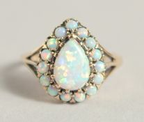 A GOOD 9CT GOLD PEAR SHAPED OPAL RING.