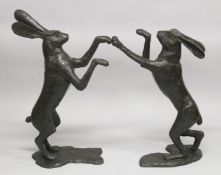 AN IMPRESSIVE PAIR OF BRONZE BOXING HARES.. 2ft 9ins high.