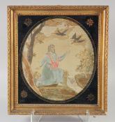 A 19TH CENTURY SILK FRAMED PICTURE OF A RELIGIOUS FIGURE. 16ins x 14ins.