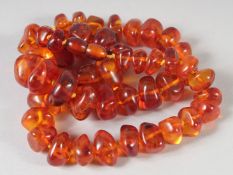 A GOOD GRADUATED AMBER NECKLACE, 50 beads, 19ins long, 60gms.
