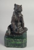 A BRONZE SEATED BEAR on a marble stand. 6ins high.