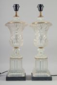 A PAIR OF GLASS URN SHAPED PEDESTAL TABLE LAMPS. 1ft 11ins high.