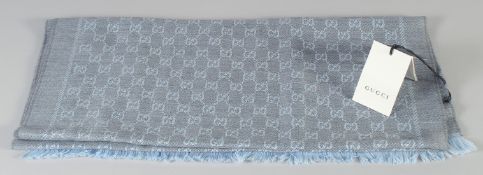 A NEW, UNUSED GUCCI BLUE-GREY SCARF. 180cm x 100cm in original box.