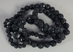 A LONG CARVED VICTORIAN GRADUATED JET NECKLACE. 32ins long. 10gms..