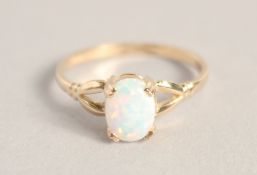 A 9CT GOLD OPAL RING.