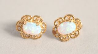 A PAIR OF SILVER 9CT GOLD OPAL FILIGREE EAR STUDS.