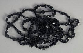 TWO LONG CARVED VICTORIAN GRADUATED JET NECKLACES. 46ins & 38ins long, 150gms.