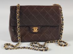 A SMALL CHANEL PADDED BLACK LEATHER SHOULDER BAG. 20cm long , 15cm high with long leather and gilt