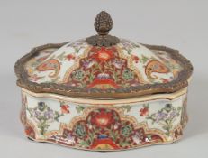 A PORCELAIN AND BRASS MOUNTED CASKET AND COVER with pineapple finial. 6ins.