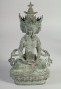 A BRONZE MULTI-HEADED SEATED EASTERN DEITY. 9ins high.
