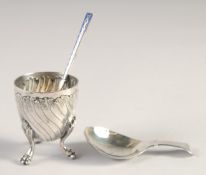 A SMALL ART NOUVEAU SILVER EGG CUP on three claw feet, blue enamel spoon. George III silver caddy