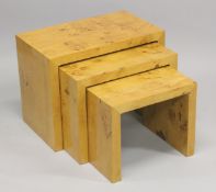 A NEST OF THREE ART DECO STYLE TABLES. Largest: 1ft 11.5ins wide x 1ft 2ins high.
