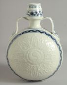 A CHINESE BLUE AND WHITE PORCELAIN TWIN HANDLED MOON FLASK, with carved ying-yang medallion
