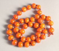 A BUTTERSCOTCH AMBER BEAD NECKLACE, twenty nine beads. Weight: 33gms, 20ins long.