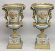 A LARGE AND IMPRESSIVE PAIR OF SEVRES STYLE BRONZE AND PORCELAIN TWIN HANDLED PEDESTAL URNS, gilt