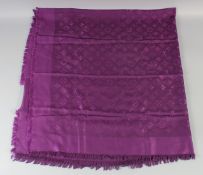 A LOUIS VUITTON PURPLE SHAWL with Louis Vuitton emblems. 140cm 120cm.