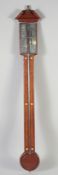 A MAHOGANY BAROMETER with engraved silver scale 3ft 3ins high.