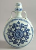 A CHINESE BLUE AND WHITE PORCELAIN TWIN HANDLED MOON FLASK, with radiating Ying-Yang symbol. 29.