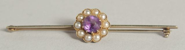 AN AMETHYST AND SEED PEARL BAR BROOCH.