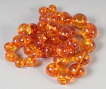 A GOOD AMBER GRADUATED BEAD NECKLACE, 23ins long, 44 beads. 50gms.