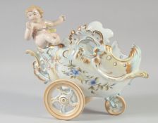 A CONTINENTAL PORCELAIN CHERUB CART. 11ins long.