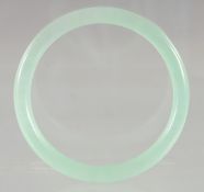 AN ICY JADE BANGLE. 3ins diameter.