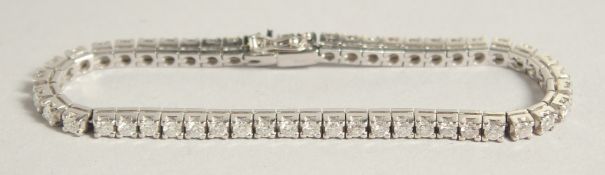 A SUPERB 18CT WHITE GOLD DIAMOND LINE BRACELET, approx. 9ct diamonds, V S , G colour.