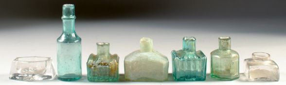 SIX VARIOUS GLASS BOTTLES AND A SALT. (7).