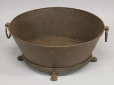 AN OVAL WROUGHT IRON TROUGH OR PLANTER with ring handles. 2ft 6ins long.