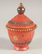 A TURKISH TOPHANE TERRACOTTA LIDDED POT, with gilt decoration, 14cm high.
