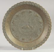 A FINE ISLAMIC EMBOSSED AND CHASES COPPER DISH, with various animals and foliate decoration, 36cm