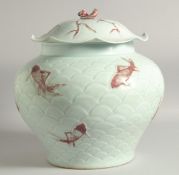 A LARGE CHINESE CELADON AND UNDERGLAZE RED JAR AND COVER, decorated with fish on carved scale