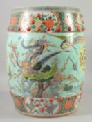 A CHINESE POLYCHROME PORCELAIN GARDEN SEAT, painted with exotic bird and flora, 45cm high.