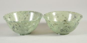 A PAIR OF CHINESE SPINACH JADE BOWLS, each 10cm diameter.