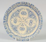 A PERSIAN -POSSIBLY SAFAVID, BLUE AND WHITE POTTERY DISH, 23cm diameter.
