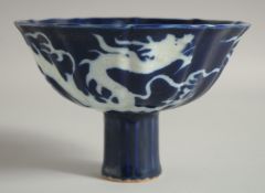 A CHINESE SACRIFICIAL BLUE PEDESTAL BOWL, with incised white dragon, bowl 16cm diameter.