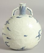 A CHINESE BLUE AND WHITE PORCELAIN TWIN HANDLE MOON FLASK, with carved dragon decoration, 25cm high