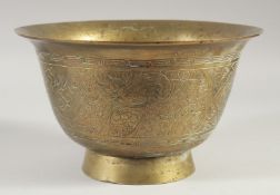 A CHINESE ENGRAVED AND CHASED BRASS BOWL, 27.5cm diameter.