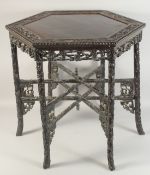 A CHINESE HEXAGONAL HARDWOOD TABLE, with carved and pierced skirt and detachable folding foliate